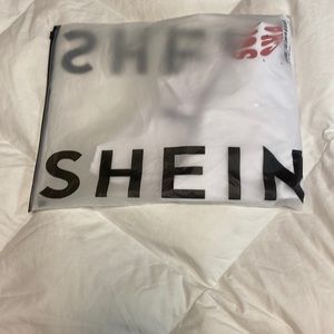 This is a tshirt that says sunset chaser on the front and back